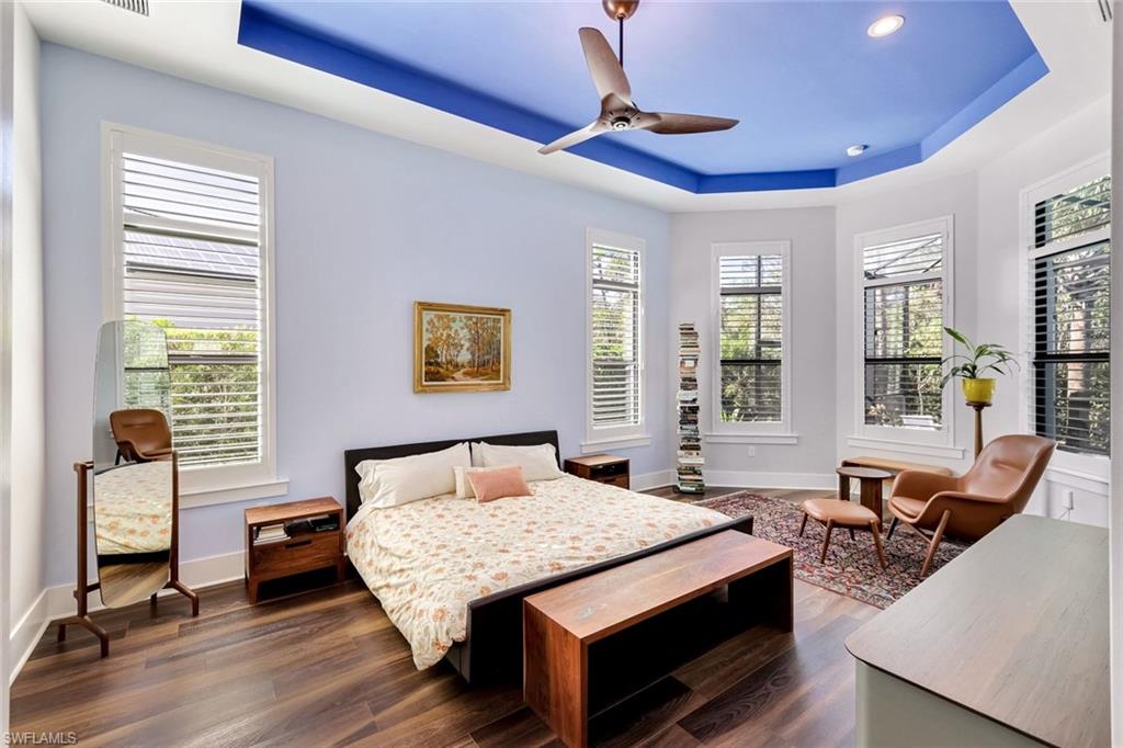 16249 Verilyn Circle Naples, FL 34110 - Photo 18 of 48 a bedroom with a bed and wooden floor