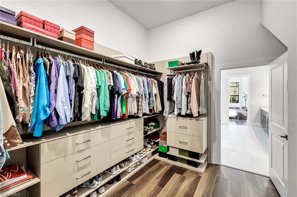 16249 Verilyn Circle Naples, FL 34110 - Photo 22 of 48 a view of walk in closet with clothes and shoes