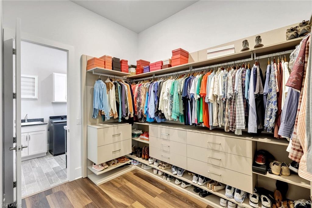16249 Verilyn Circle Naples, FL 34110 - Photo 23 of 48 a view of walk in closet with clothes and shoes