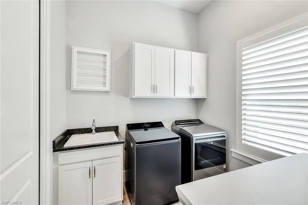 16249 Verilyn Circle Naples, FL 34110 - Photo 24 of 48 a kitchen with stainless steel appliances granite countertop a sink a stove and a refrigerator