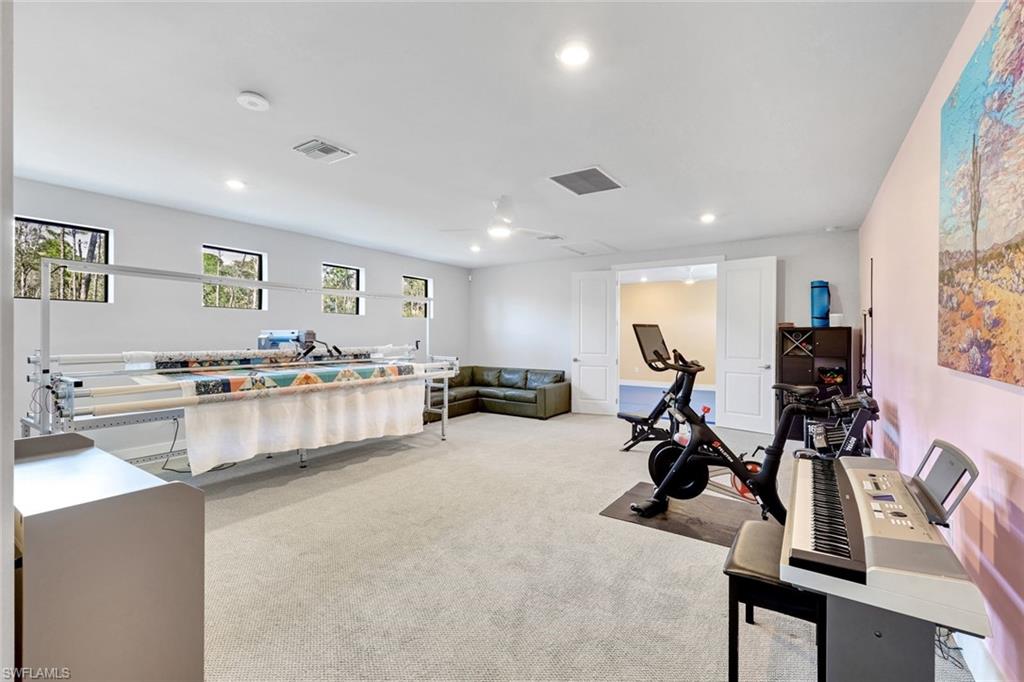 16249 Verilyn Circle Naples, FL 34110 - Photo 26 of 48 a living room with furniture a flat screen tv and a window