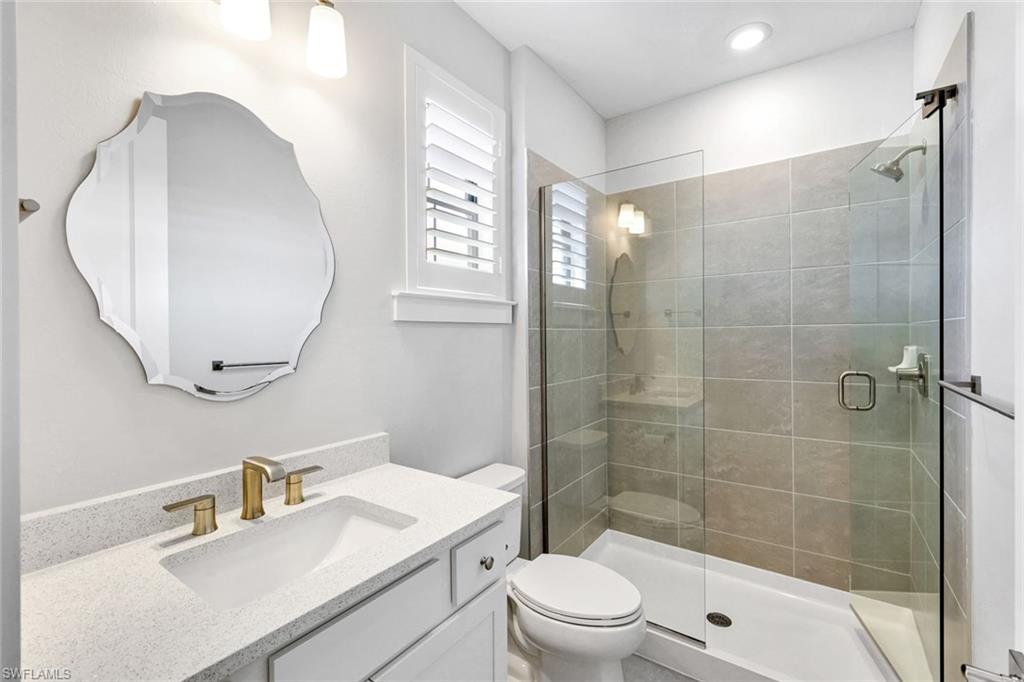 16249 Verilyn Circle Naples, FL 34110 - Photo 28 of 48 a bathroom with a sink toilet a mirror and shower