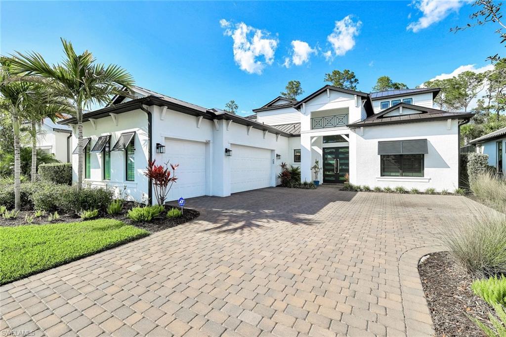 16249 Verilyn Circle Naples, FL 34110 - Photo 3 of 48 a front view of a house with garden
