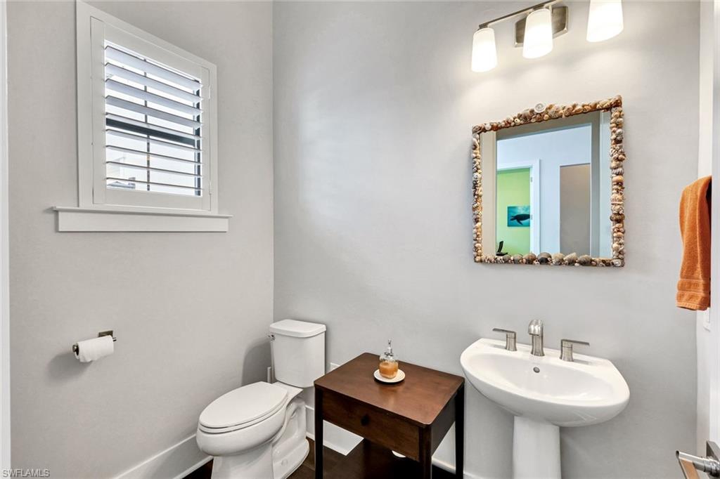16249 Verilyn Circle Naples, FL 34110 - Photo 32 of 48 a bathroom with a toilet sink and mirror