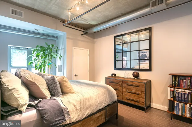 a bedroom with a bed and a window