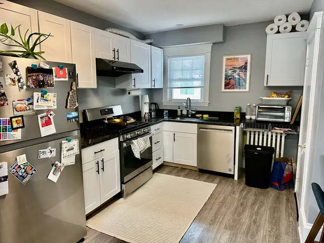 a kitchen with stainless steel appliances granite countertop a stove a sink and a refrigerator