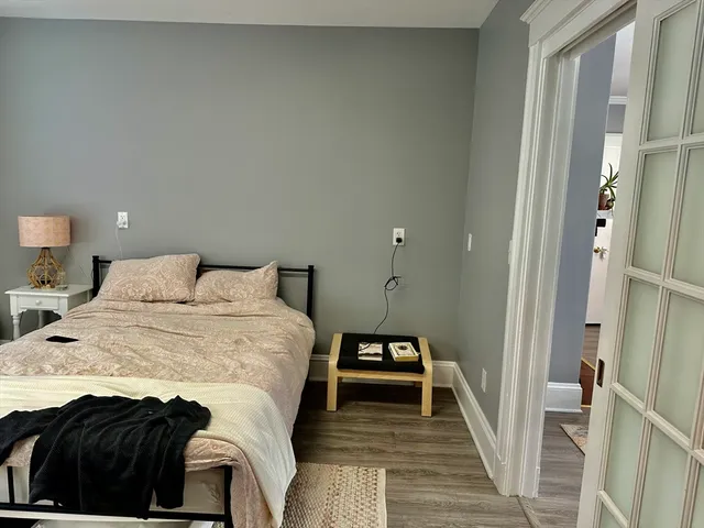 a bed room with a bed and a wooden floor