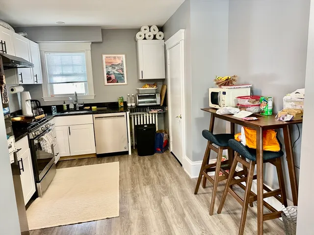 a kitchen with a sink appliances and cabinets