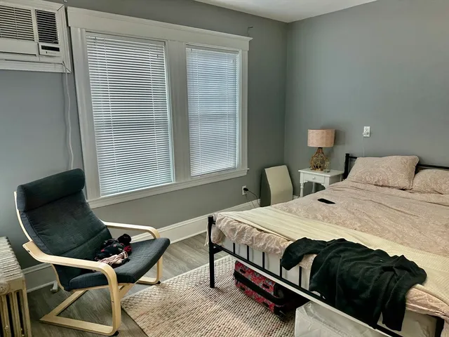a bedroom with a bed and chair