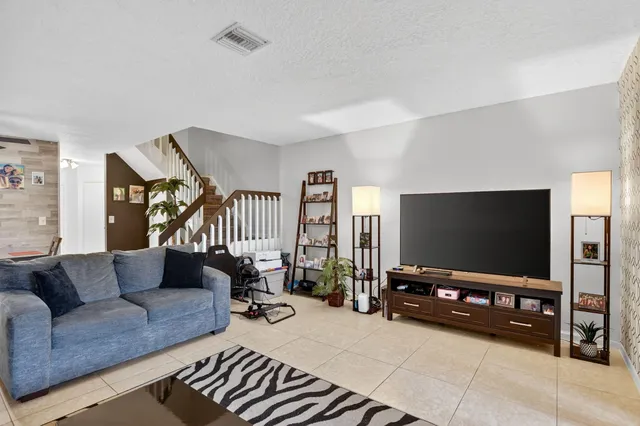 a view of a dining room with furniture and a potted plant