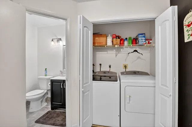 a bedroom with bed and a chandelier