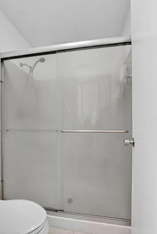 a bedroom with a bed and a wooden floor