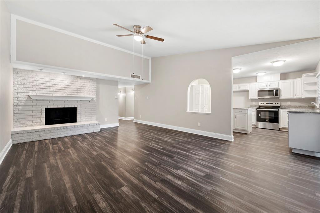 928 Overdowns Drive Plano, TX 75023 - Photo 3 of 11 a view of empty room with wooden floor and fireplace