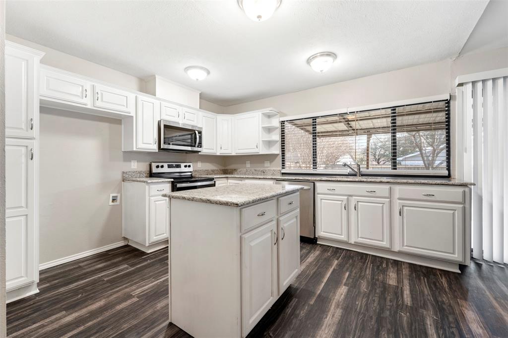928 Overdowns Drive Plano, TX 75023 - Photo 4 of 11 a kitchen with white cabinets and appliances