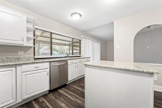 a kitchen with granite countertop cabinets stainless steel appliances and a granite counter tops