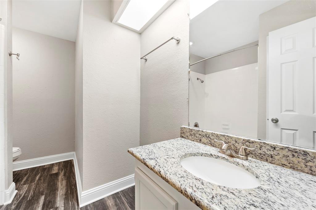 928 Overdowns Drive Plano, TX 75023 - Photo 10 of 11 a bathroom with a granite countertop sink and a mirror