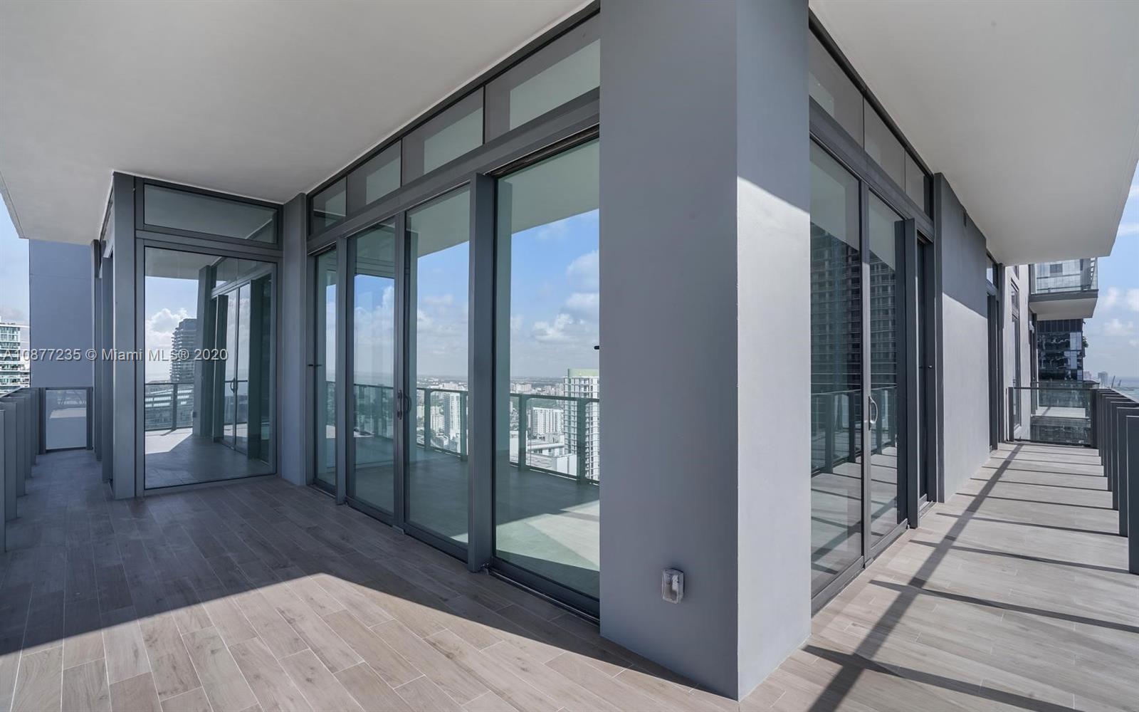 88 Southwest 7th Street, Unit 4001 Miami, FL 33130 - Photo 12 of 21 a view of a hallway with wooden floor and glass door