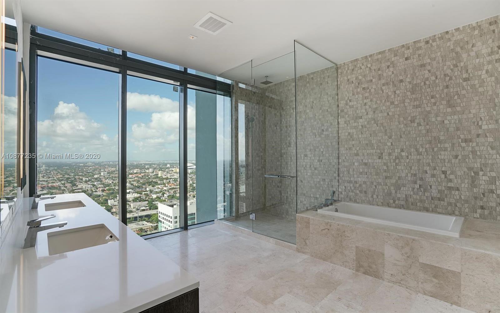 88 Southwest 7th Street, Unit 4001 Miami, FL 33130 - Photo 17 of 21 a bathroom with a tub and shower