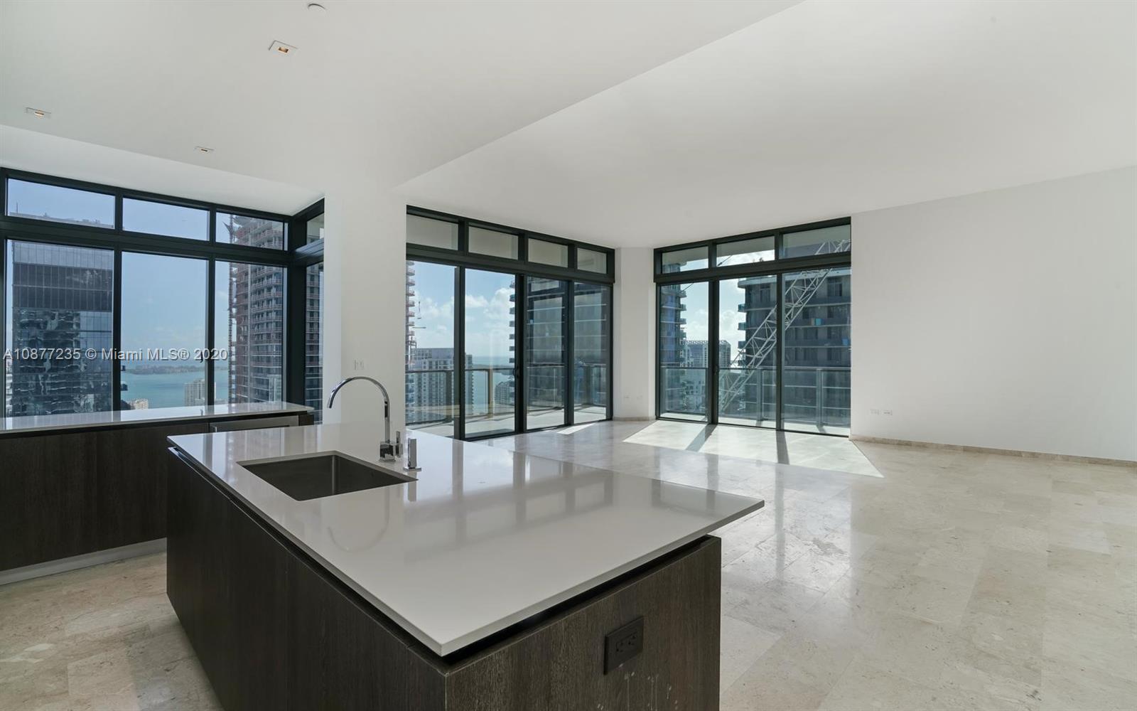 88 Southwest 7th Street, Unit 4001 Miami, FL 33130 - Photo 3 of 21 a kitchen with granite countertop a sink and a counter top space