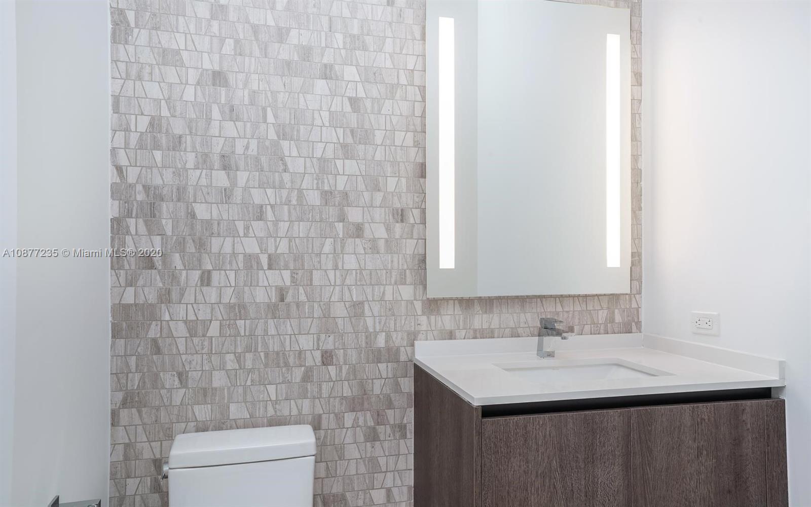 88 Southwest 7th Street, Unit 4001 Miami, FL 33130 - Photo 7 of 21 a bathroom with a sink toilet and a mirror