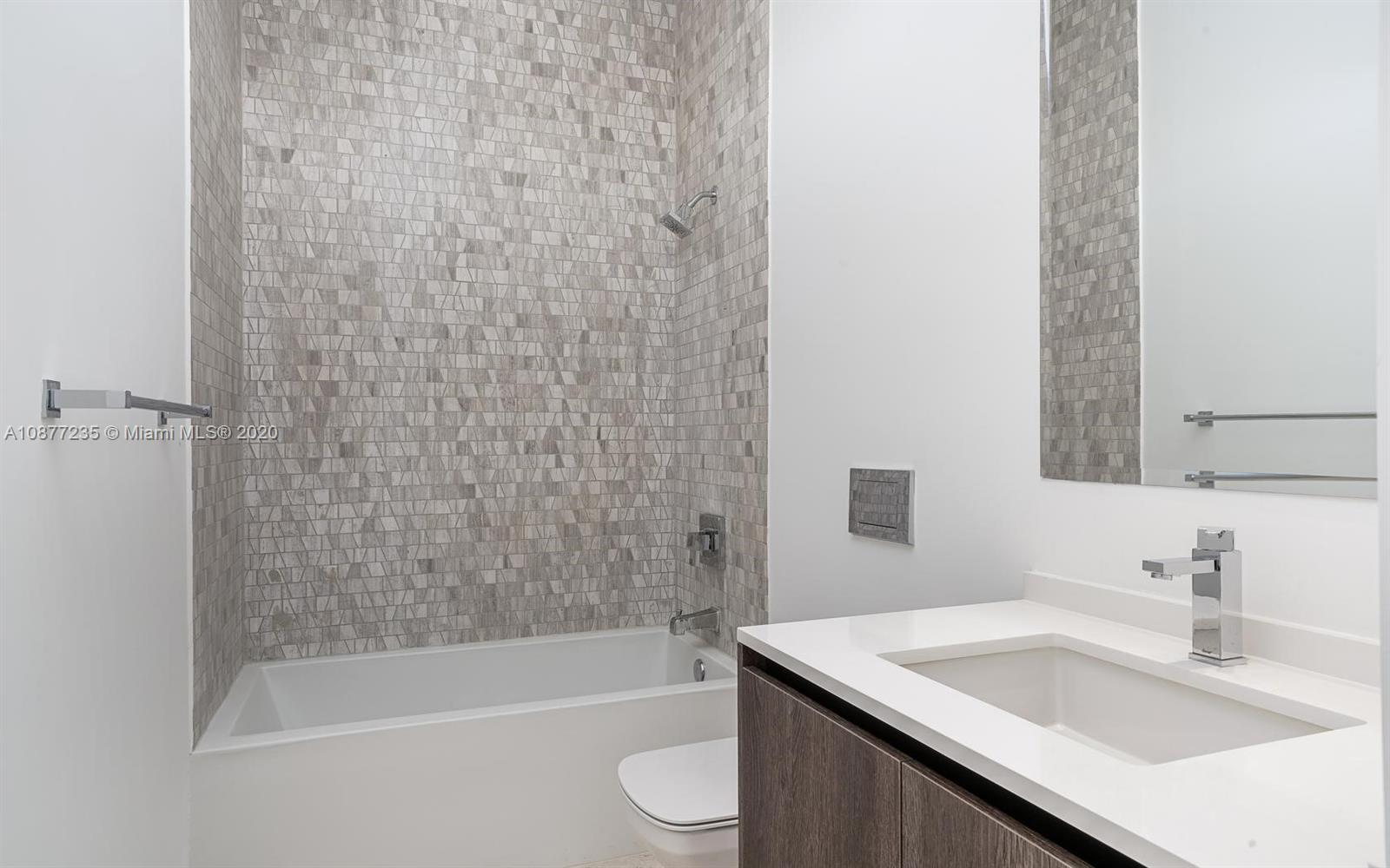 88 Southwest 7th Street, Unit 4001 Miami, FL 33130 - Photo 8 of 21 a bathroom with a granite countertop sink toilet and shower