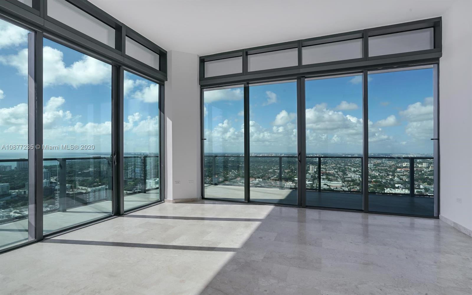 88 Southwest 7th Street, Unit 4001 Miami, FL 33130 - Photo 9 of 21 a view of an empty room with wooden floor and a balcony