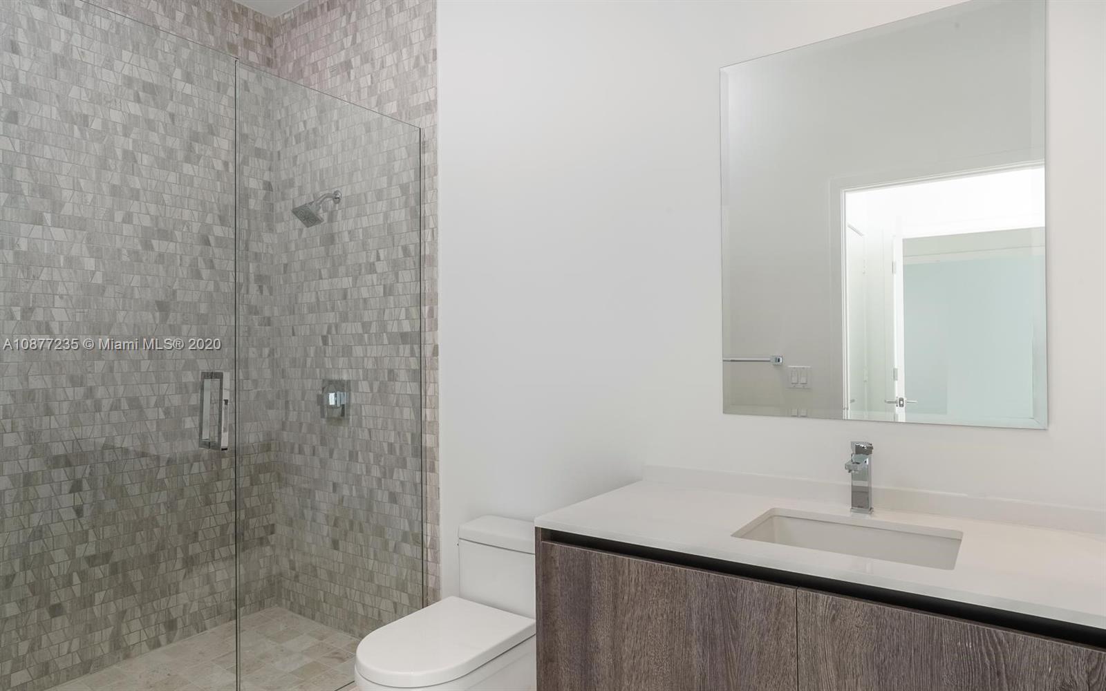 88 Southwest 7th Street, Unit 4001 Miami, FL 33130 - Photo 10 of 21 a bathroom with a granite countertop sink toilet and shower