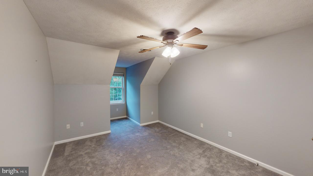 202 Lakeside Loop Ridgeley, WV 26753 - Photo 26 of 45 an empty room with a ceiling fan and a window
