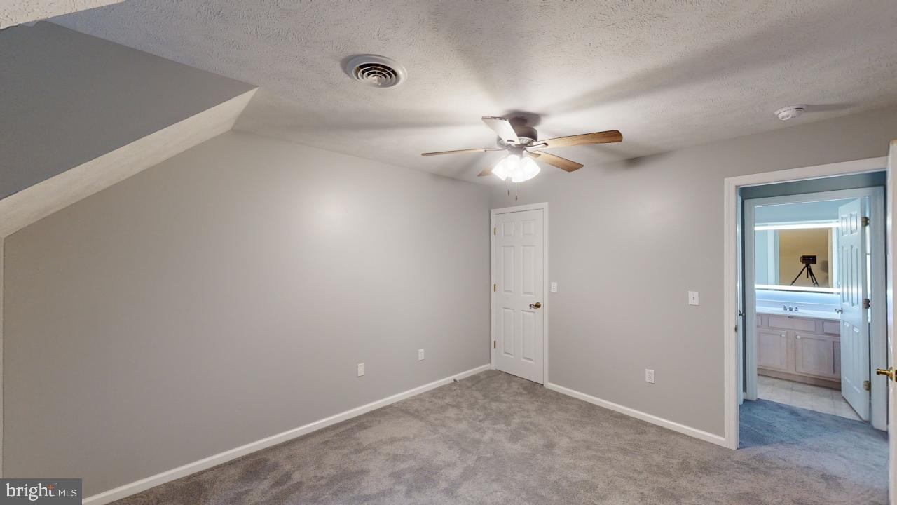 202 Lakeside Loop Ridgeley, WV 26753 - Photo 27 of 45 an empty room with a ceiling fan and a window