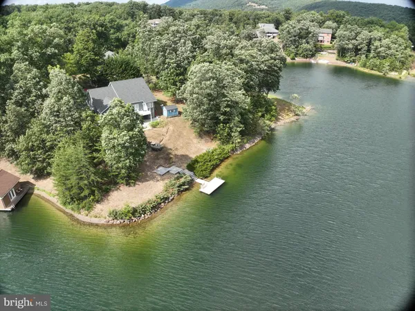 an aerial view of a house with a yard basket ball court and outdoor seating