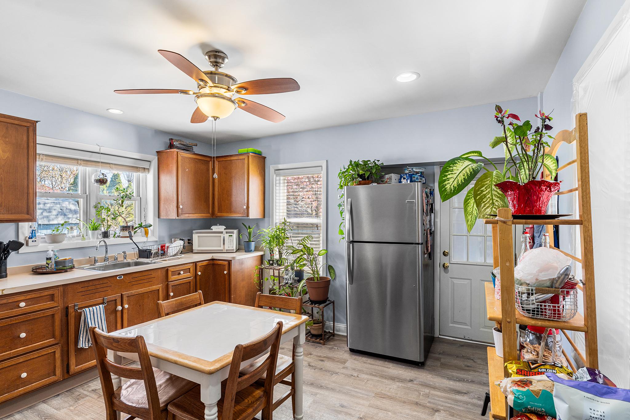 16 Volusia Avenue Hamilton, NJ 08610 - Photo 12 of 50 a kitchen with a refrigerator a microwave a stove and wooden floor