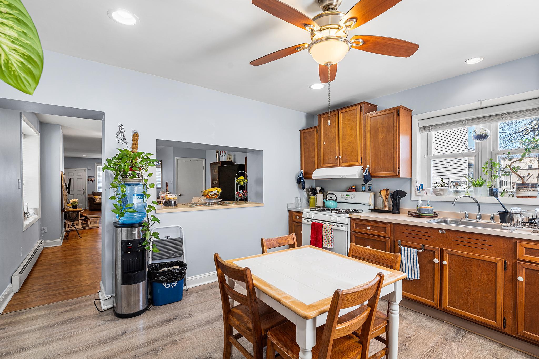 16 Volusia Avenue Hamilton, NJ 08610 - Photo 9 of 50 a kitchen with a table chairs sink and cabinets