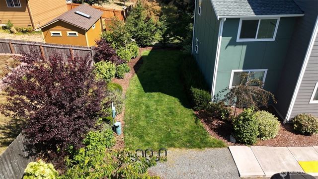 a sign that is sitting in front of flowers
