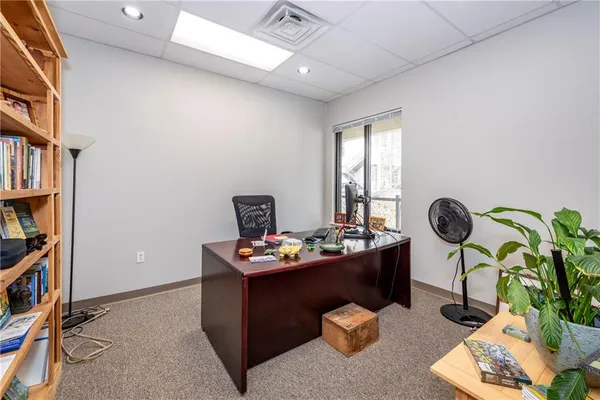a workspace with furniture and bookshelf