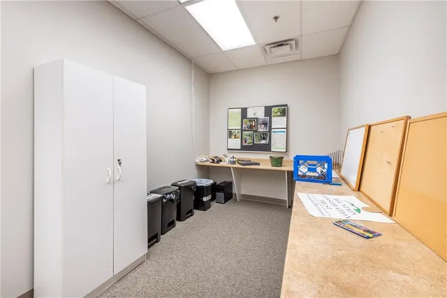 a reading room with furniture a rug and a window