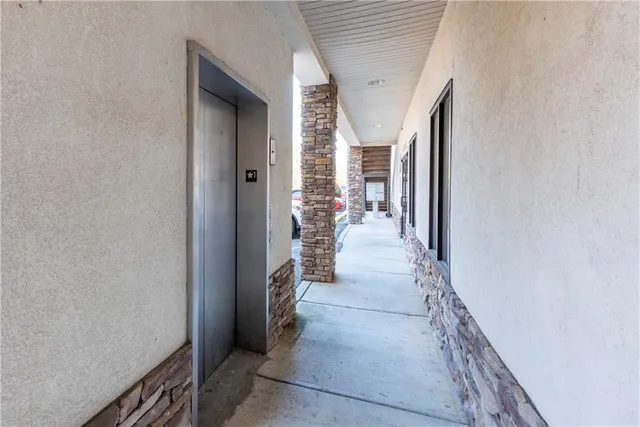 a hallway with a white stove next to a window