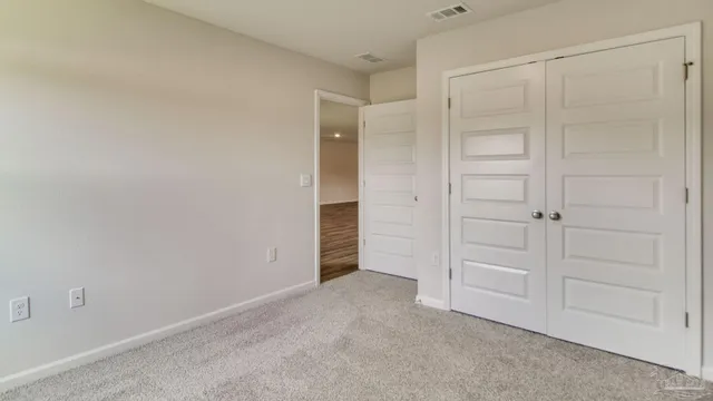 an empty room with closet area