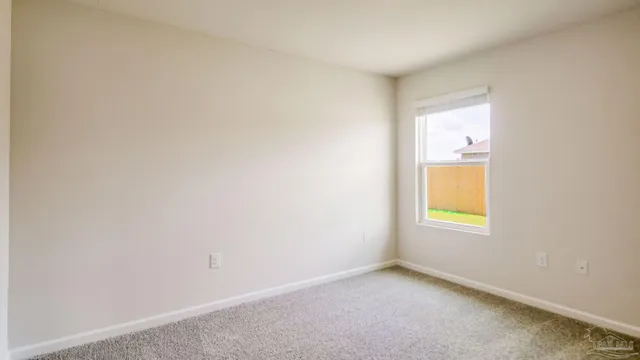 an empty room with a window and a sink