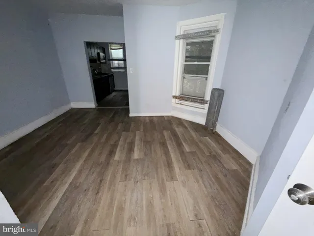 a view of a hallway view with wooden floor and staircase