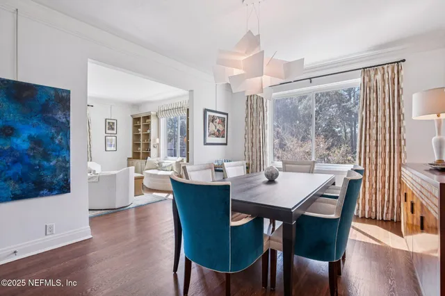 a view of a dining room with furniture and wooden floor
