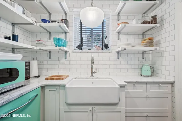 a bathroom with a sink and a stove with wooden floor