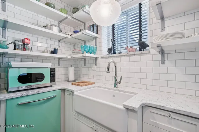 a kitchen with a sink and a stove top oven