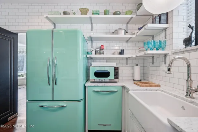 a kitchen with a refrigerator and a sink