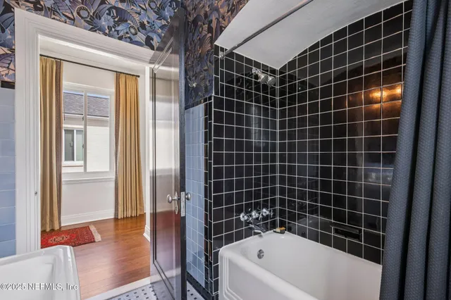 a bathroom with a bathtub and a shower