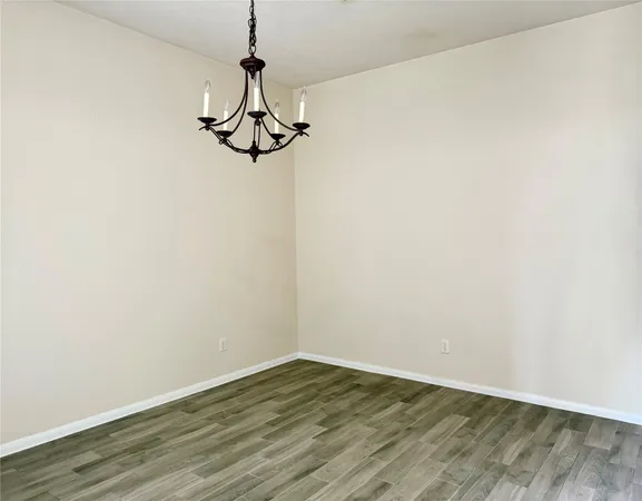 a view of a room with wooden floor and white walls