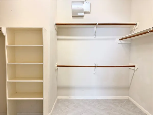 a view of a closet with wooden floor