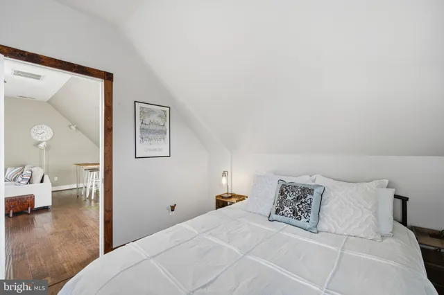 a bedroom with a bed and a view of bathroom