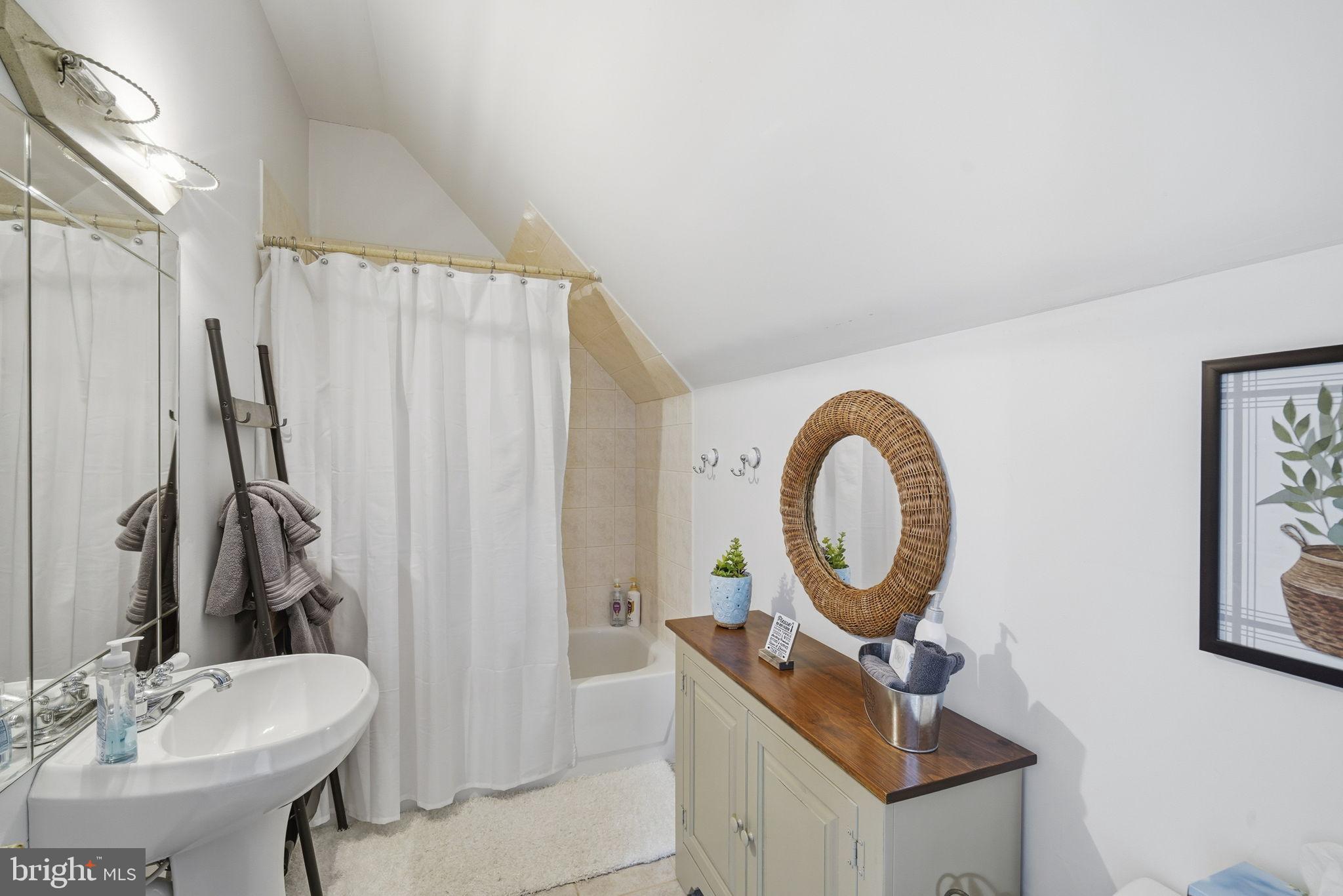 32135 River Road Millington, MD 21651 - Photo 21 of 33 a bathroom with a sink a mirror and a shower