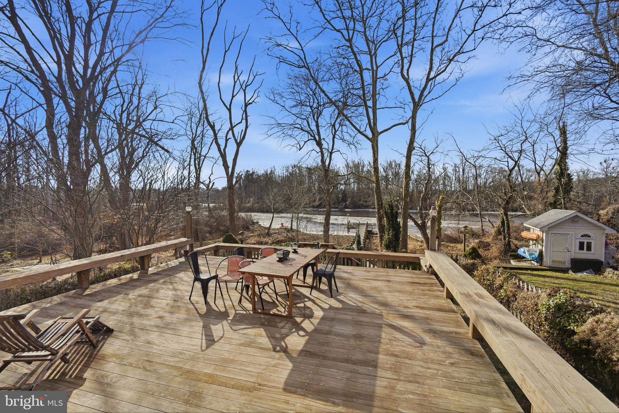 32135 River Road Millington, MD 21651 - Photo 22 of 33 a view of a patio with table and chairs and wooden floor