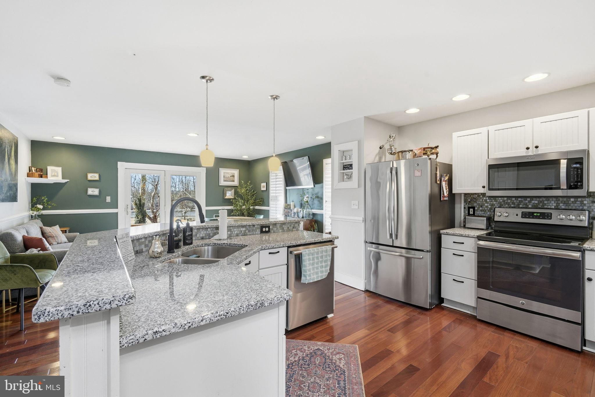 32135 River Road Millington, MD 21651 - Photo 6 of 33 a kitchen with stainless steel appliances granite countertop a sink refrigerator and microwave